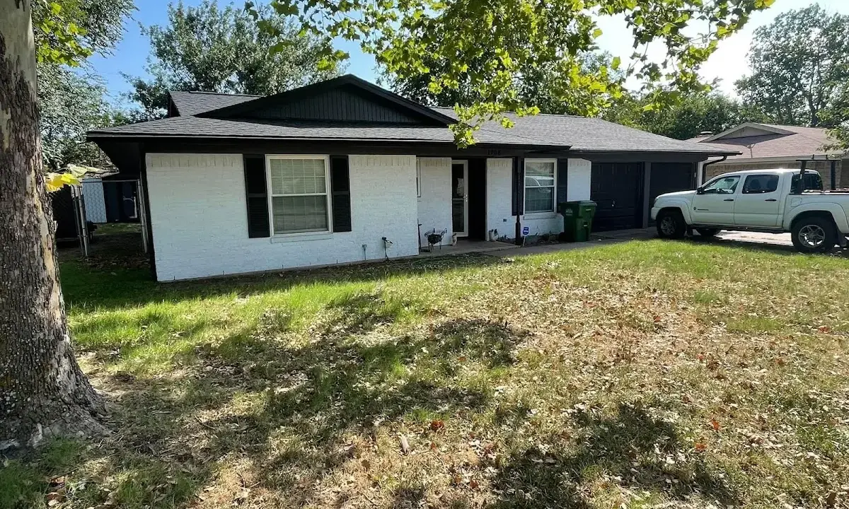 Professional roofing crew working on a residential roof in June Park